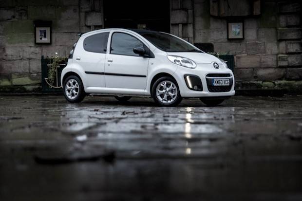 White car on rainy road