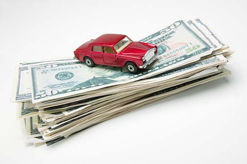 Toy car on top of money