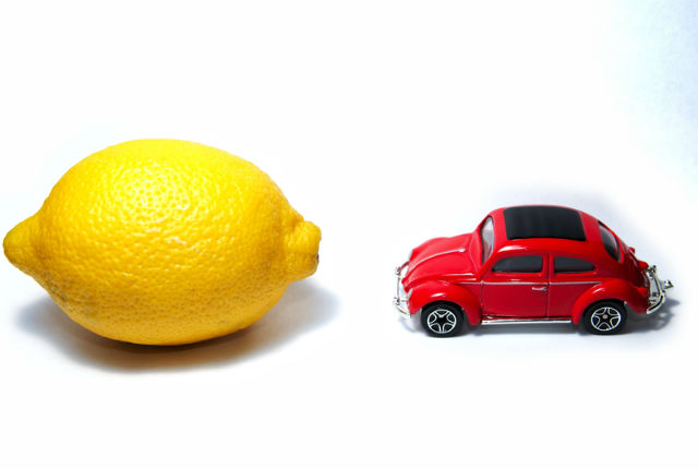 Red car facing lemon