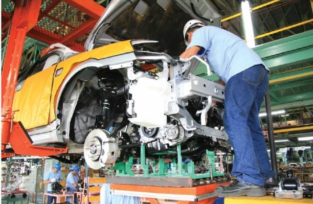 Mechanic fixing car in repair shop
