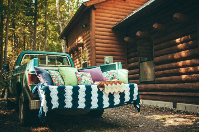 Green pickup truck with cushions and blankets