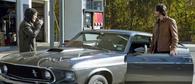 John Wick refilling his Ford Mustang at a gas station