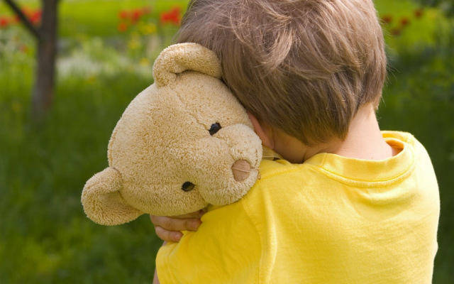 Boy hugging a teddy bear