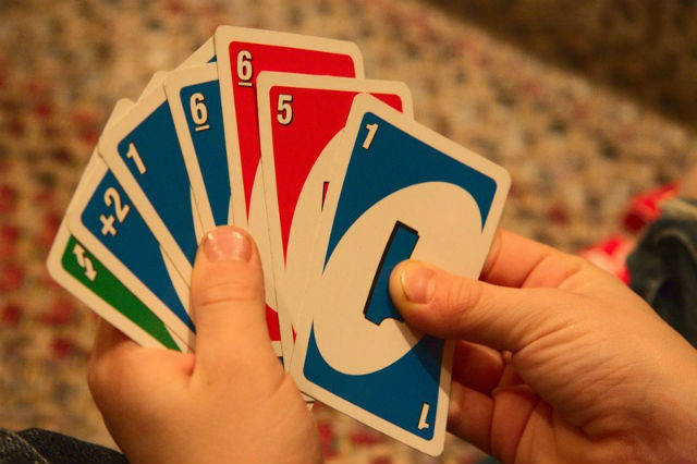 Person holding playing cards