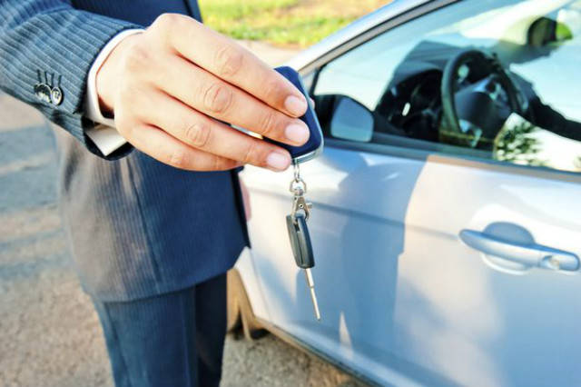 Car salesman handing over the keys
