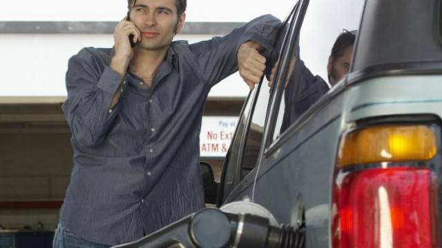 Man using phone while refuelling.