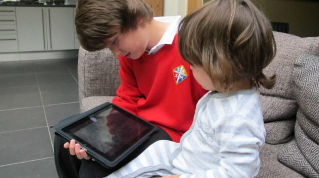 Two kids using a tablet