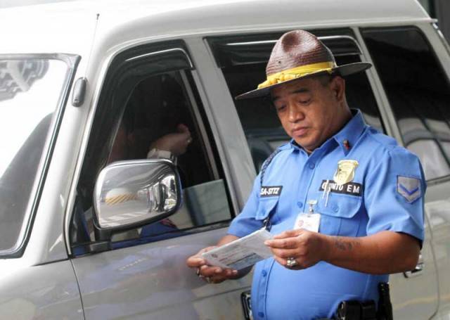 Traffic enforcer checking license of a driver