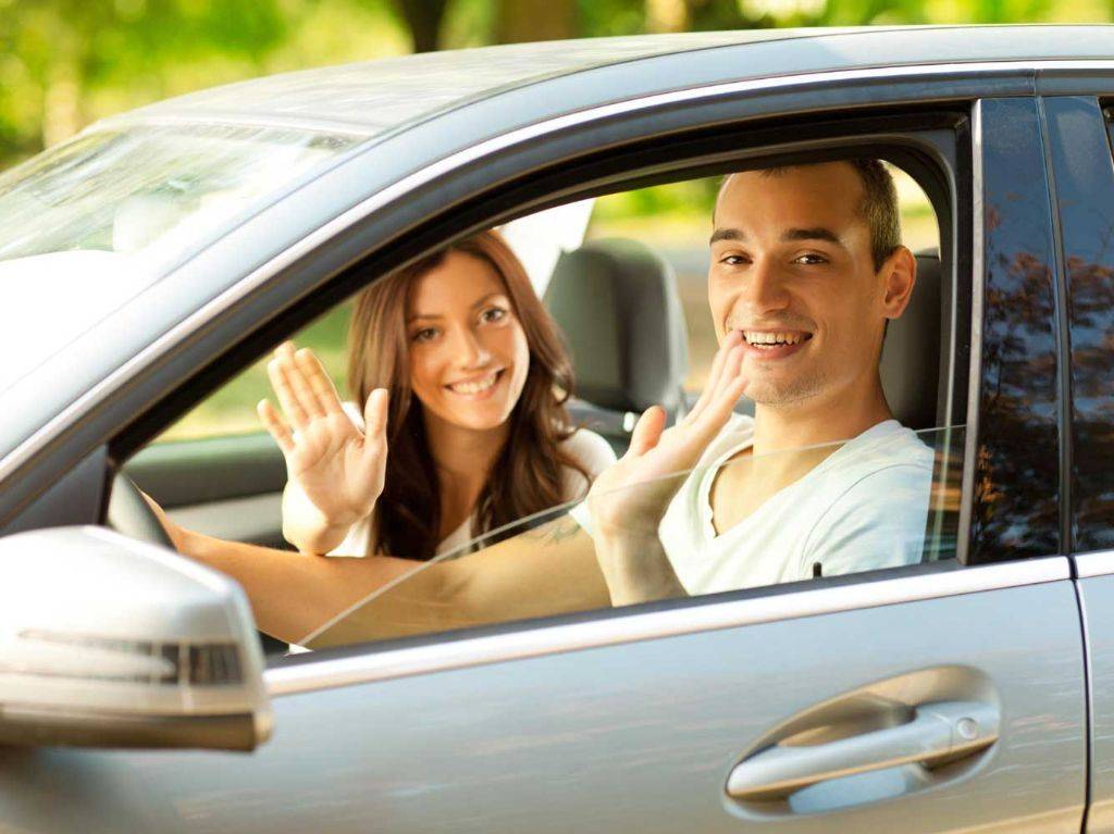 Leaving car. Waving to stop a car.