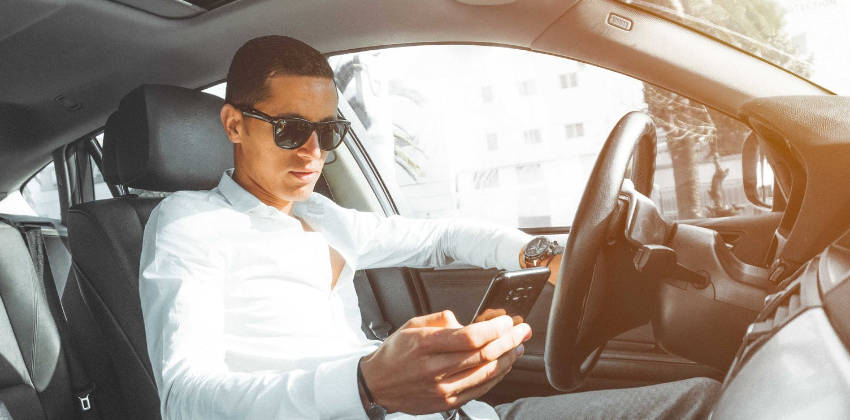 Man texting in car