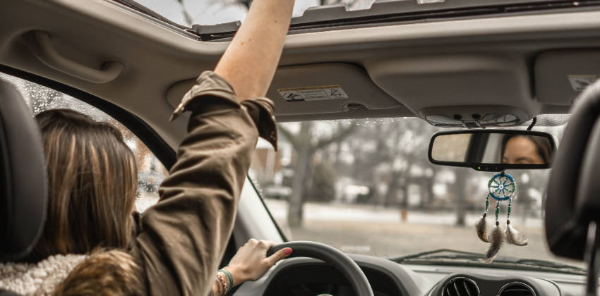 Woman waving in a car