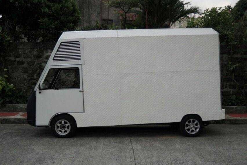 Atoy Llave's isolation facility using Suzuki Super Carry closed van